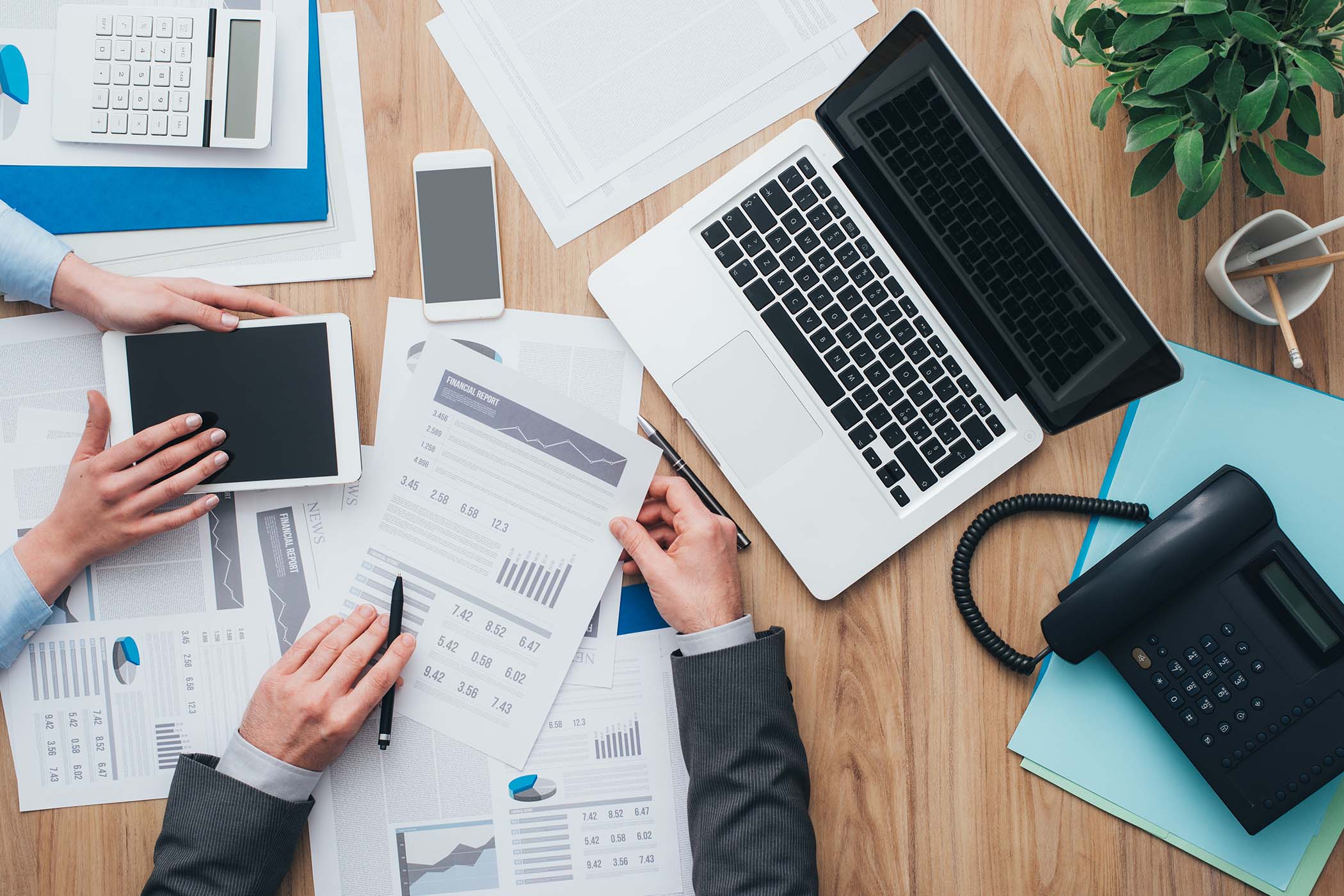 coworkers-paperwork-laptop-phone